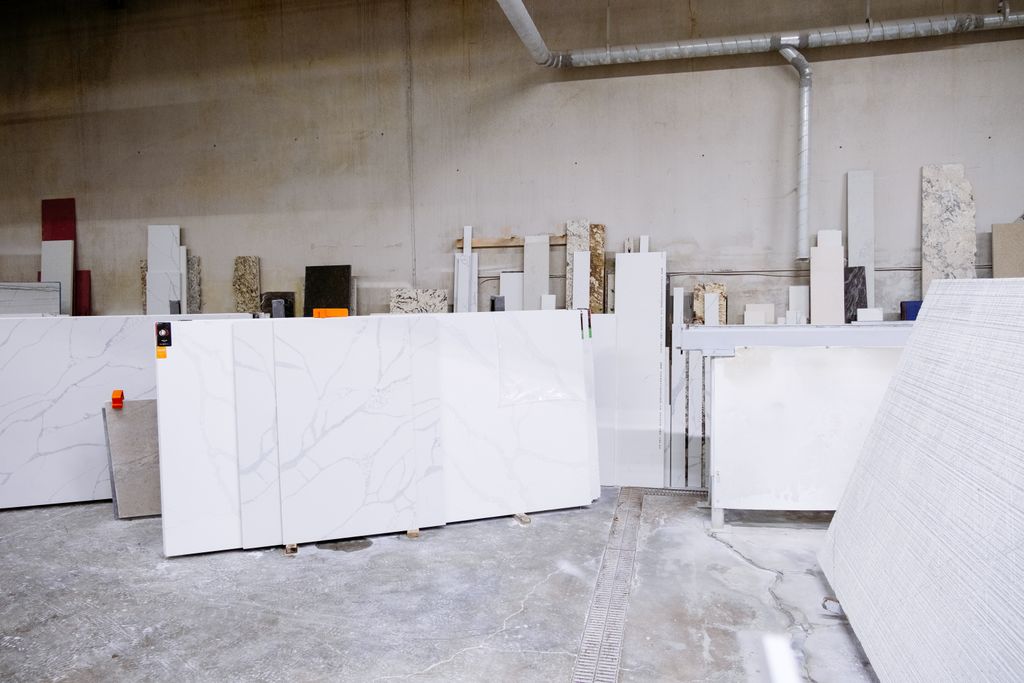 Granite and stone slabs in a manufacturing facility showing industrial processes.